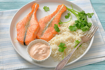 baked salmon steaks with rice, cilantro and sauce