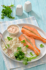 baked salmon steaks with rice, cilantro and sauce