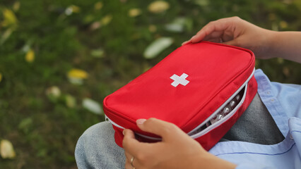 First aid kit. First aid kit in autumn park. Autumn park. High quality photo.