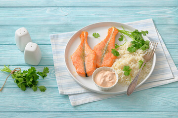 baked salmon steaks with rice, cilantro and sauce