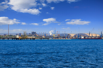 Taranto cityscape: view of the port with industrial zone in Apulia, southern Italy.