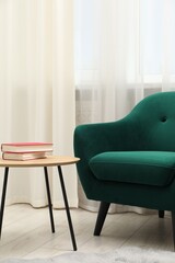 Stylish furniture near window with curtains in living room. Interior design