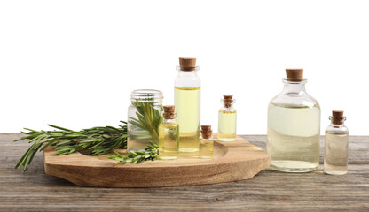 Bottles of essential oils and rosemary on wooden table against background