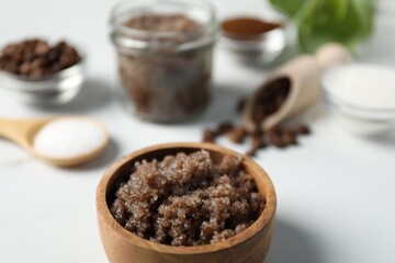 Natural body scrub and ingredients on white table, closeup