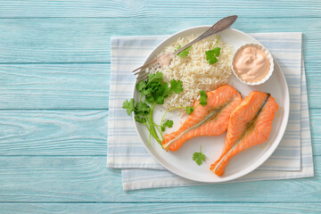 baked salmon steaks with rice, cilantro and sauce