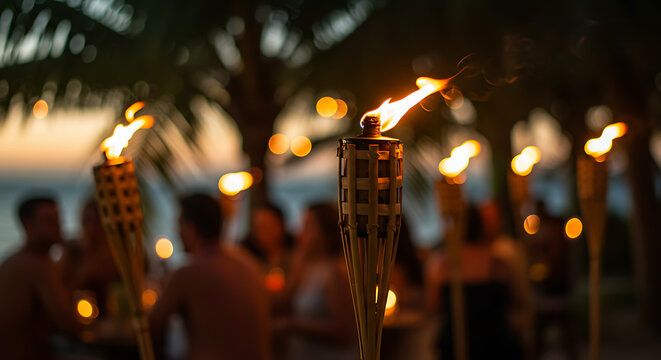 Tropical beach party with lit torches and guests enjoying evening
