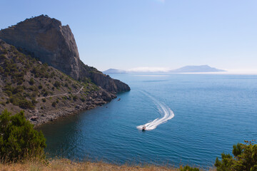 Sea view with a boat and mountains . Summer view . Article about travel