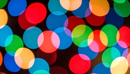 Vibrant circular lights create a colorful pattern of overlapping circles against a dark background.