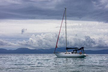 Sailboat off the coast with dramatic clouds in the background. Adriatic Sea, Croatia