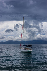 Naklejka premium Sailboat off the coast with dramatic clouds in the background. Adriatic Sea, Croatia