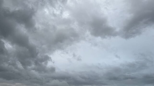 Dramatic dark storm clouds moving rapidly across a gloomy overcast sky. Concept of approaching storm.