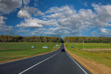 Autumn landscape and sunny evening, orange road and highway, asphalt and roadside.