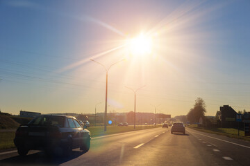 Autumn landscape and sunny evening, orange road and highway, asphalt and roadside.