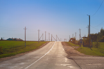 Fototapeta premium Autumn landscape and sunny evening, orange road and highway, asphalt and roadside.