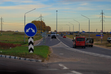 Autumn landscape and sunny evening, orange road and highway, asphalt and roadside.