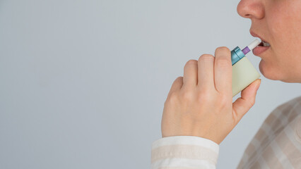 Caucasian woman smoking electronic cigarette. Tobacco heating system.