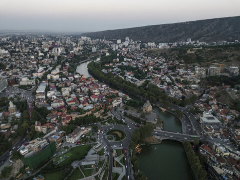 Aerial view of the Mtkvari River snaking through the city, punctuated by the Narikala Fortress perched high above, Tbilisi, Tbilisi, Georgia.