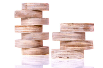 Side view of round plywood blanks standing and lying on each other for crafts and decorative...
