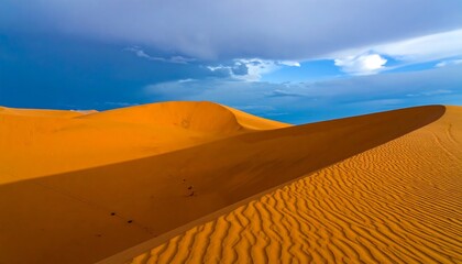 Vast, vibrant orange dunes rise beneath a dramatic, colorful sky, showcasing the grandeur of nature's sculpted landscape.