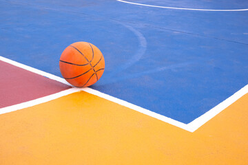Basketball court with colorful pattern and basketball on concrete floor surface, Outdoors sport field background © Prapat