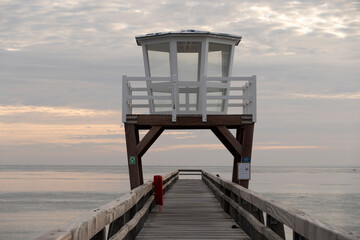 Luc-Sur-Mer, France - 08 07 2025: View of the wooden pier in front of the sea named Fisherman's Pier at sunrise