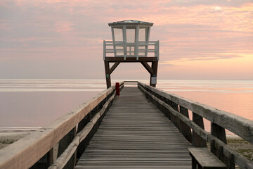 Luc-Sur-Mer, France - 08 07 2025: View of the wooden pier in front of the sea named Fisherman's Pier at sunrise