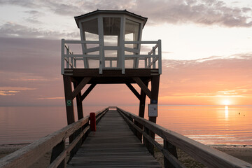 Luc-Sur-Mer, France - 08 07 2025: View of the wooden pier in front of the sea named Fisherman's Pier at sunrise