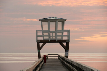 Luc-Sur-Mer, France - 08 07 2025: View of the wooden pier in front of the sea named Fisherman's Pier at sunrise
