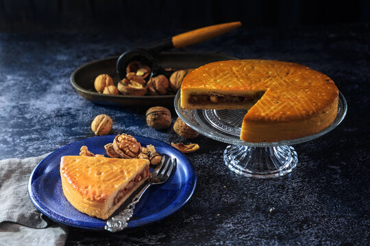 Engadine Walnuts Torte or Buendner Nusstorte on glass plate, a Swiss confectionery spacialty in Grisons - dark and moody