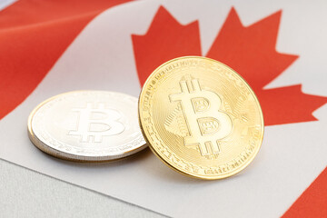 Bitcoin cryptocurrency coins on national flag of Canada. Crypto law regulation concept