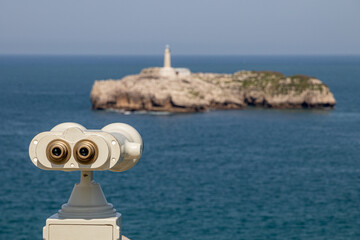 Santander, Cantabria, Spain. Tourist telescope on Magdalena Peninsula viewing Mouro Island...
