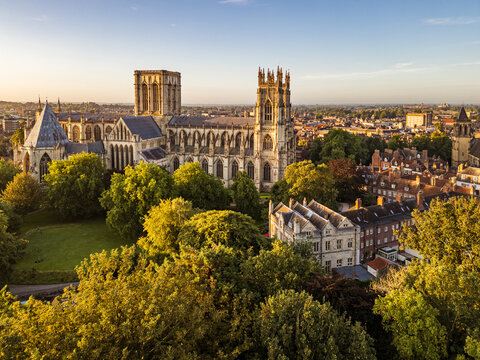 Aerial view of York Minster in York, North Yorkshire, UK, at sunrise, showing the medieval cathedral&rsquo;s intricate Gothic architecture and surrounding historic cityscape on a summer morning August 2025.