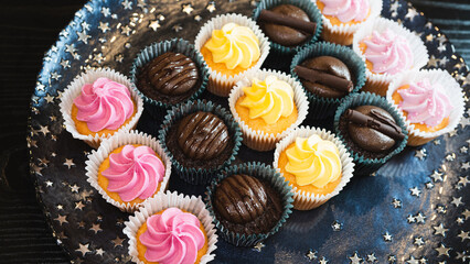 Beautiful chocolate and assorted cupcakes on an elegant plate, perfect for parties or family gatherings. Soft lighting and shallow depth of field.