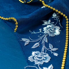 Dark blue fabric with floral embroidery and gold beads