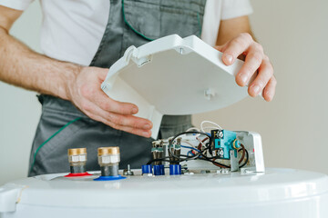 Technician repairing an electric water heater