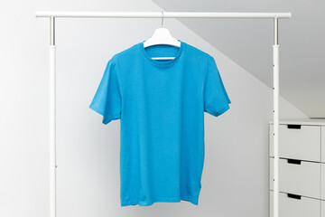 T-shirt hanging on Clothing rack. Round neck blue color. Template, mock up
