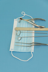 Reusable Metal Instruments Dentist Otorhinolaryngologist On Blue Background Nasal Speculum Big And Small Dental Mirrors Spatula Forceps