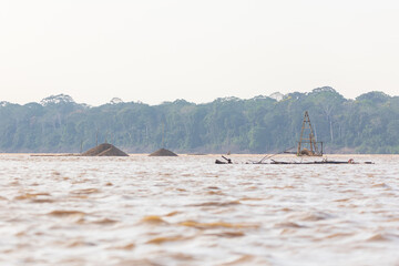 Illegal mining in Amazonian rivers like the Madre de Dios in Peru, gold dredges extracting gold...