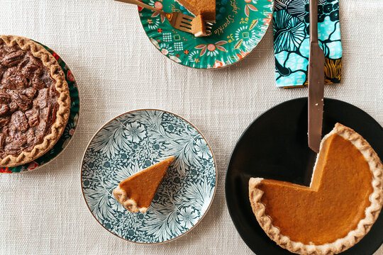 Homemade pecan and pumpkin pie desserts served at holiday dinner table