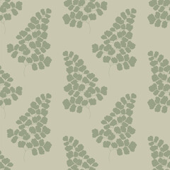 Seamless pattern with green maidenhair fern leaves on a light green background.	