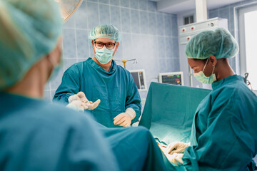 Surgeons Collaborating in a Modern Operating Room During a Surgical Procedure with Focused Teamwork