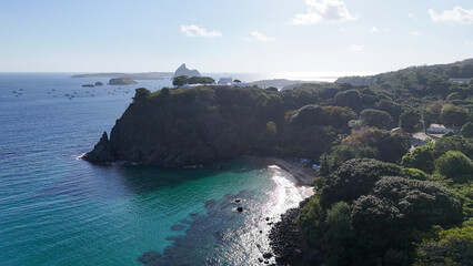 Visão aérea do Forte de Noronha, marco histórico cercado por mar cristalino e vegetação,...