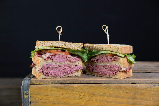Corned beef sandwich on wheat bread with lettuce and tomato 