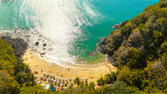 Praia do Cachorro in Fernando de Noronha, a small yet iconic beach known for crystal-clear water, rocky coast, and vibrant tropical scenery in Brazil
