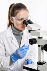 Fototapeta premium Scientist conducts research using microscope in a laboratory setting during the day in a well-lit environment
