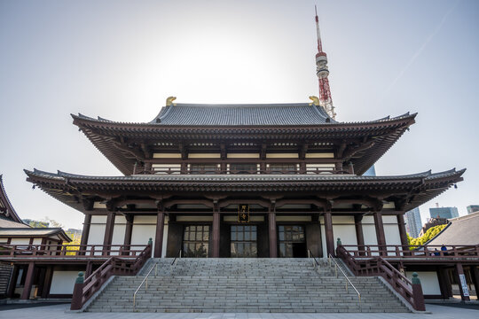 Zojoji temple, built in 1393 during the Muromachi period, stands with Tokyo Tower. Representing past-future old-new styles. Contrast in architectural design.