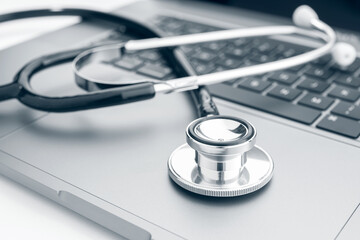 Computer diagnose concept. Stethoscope on modern laptop computer