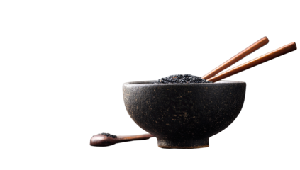 Dark whole grains in a bowl, wooden chopsticks and spoon
