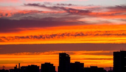 Striking sunset over a city skyline.