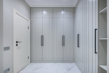 A modern entrance hall with elegant spacious storage cabinets. Minimalistic design, comfort and...
